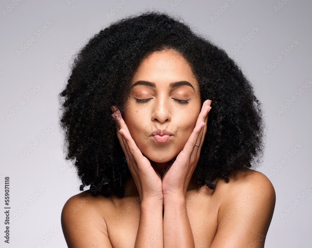 Wall mural Face kiss, beauty skincare and black woman with eyes closed in studio isolated on a gray background. Makeup, natural cosmetics and young female model pouting lips satisfied with spa facial treatment.