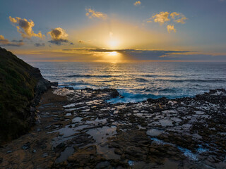 Sunrise over the ocean and rock platform