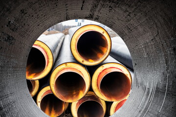 Insulated pipe. Large metal pipes with a plastic sheath at a construction site. Modern pipeline for...