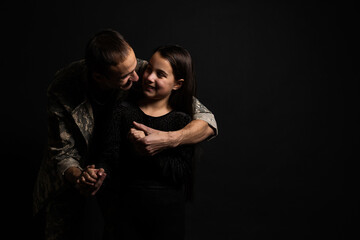 military man and daughter on a black background