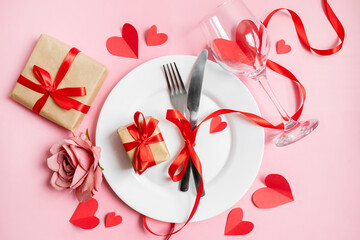 classic festive table setting in valentine's day style with gifts and hearts on a pink background. copy space. top view. 14 february concept - obrazy, fototapety, plakaty