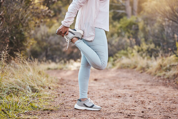 Woman stretching legs in forest and fitness, run outdoor with nature for cardio and health. Runner...