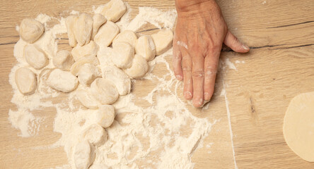 Rolling out the dough with your hands.