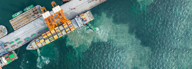 Crane loading cargo box to Large container Ship at Cargo Sea Port. Freight shipping container box...