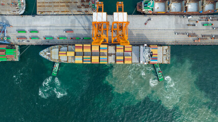 Crane loading cargo box to Large container Ship at Cargo Sea Port. Freight shipping container box transportation and logistics to Customs sea port.