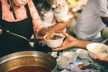The concept of humanitarian assistance: sharing food to the poor.