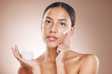 Skincare, beauty and woman with cream glow, face cosmetics and advertising spa product on a studio background. Collagen, dermatology and portrait of a model marketing sunscreen for facial health