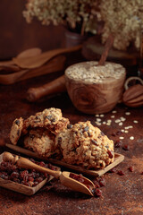 Oatmeal raisin cookies on a brown table.