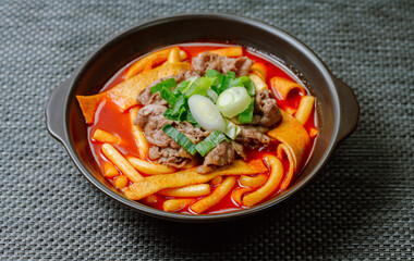 Tteokbokki, Stir-fried Rice Cake : Sliced rice cake bar (garaetteok) or thin rice cake sticks (Tteokbokkitteok) stir-fried in a spicy gochujang sauce with vegetables and fish cakes.
