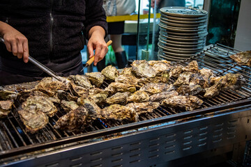 the closeup image of grilled oyster provided by local restaurant in Itsukushima， part of the city of Hatsukaichi in Hiroshima Prefecture Japan.  Oyster is popular and famous local food. 