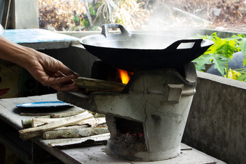 Cooking using a brazier instead of using an electric stove.