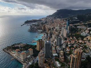 Fototapeta na wymiar Aerial panoramic view of Monte Carlo. Monaco is a country on the French Riviera in Europe. Drone view of the famous city on the Mediterranean Sea, Monte Carlo casino in the city center, Marina Port.
