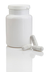 White medicine bottle and capsules