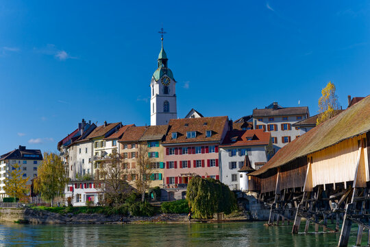 Medieval skyline of the old town of City of Olten, Canton of Solothurn, with Aare River and wooden covered bridge on a sunny autumn day. Photo taken November 10th, 2022, Olten, Switzerland.