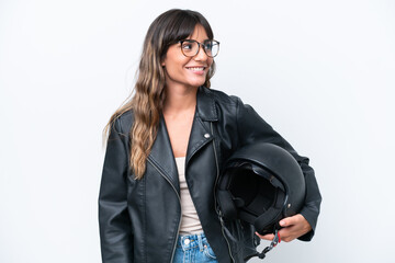 Young caucasian woman with a motorcycle helmet isolated on white background looking side