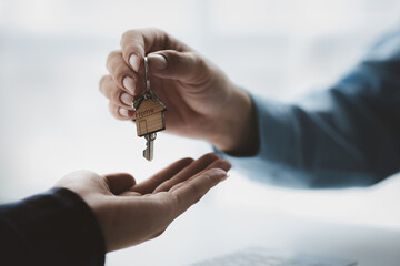 Real estate agents explain models of housing estates in projects to elaborate to clients,...