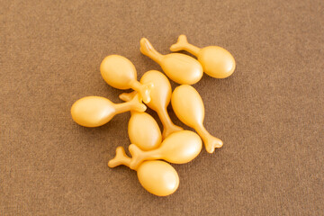 capsules with a cream or serum for face treatment on beige background. Single dose capsules for beauty care. collagen peptides or hyaluronic acid. Skin care background in minimal style.