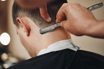Fototapeta Barber shaving bearded man with retro knife obraz