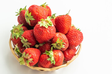 Fresh juicy strawberries in an old wicker basket