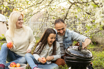 Happy family having barbecue with modern grill outdoors