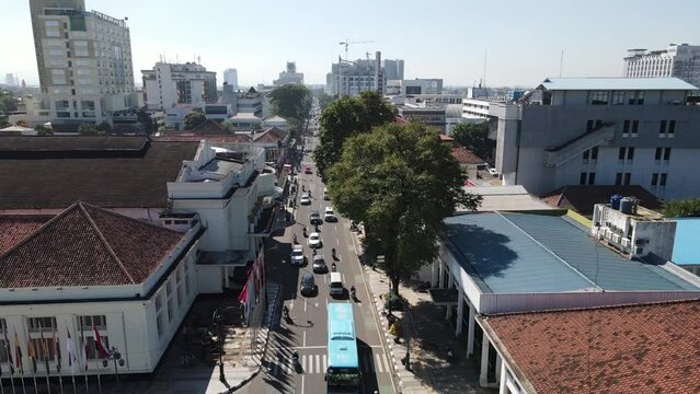 Traffic on Historical Asia Africa Street and Merdeka Building in Bandung, West Java, Indonesia view from the high.