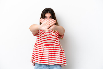 Young caucasian woman isolated on white background making stop gesture with her hand to stop an act