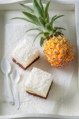 Tasty white cake made of coconut and pineapple.