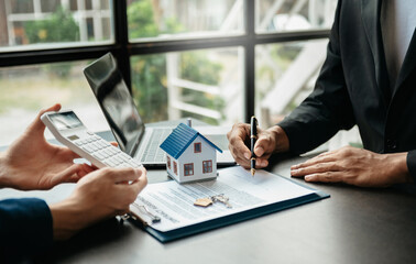 Real estate broker agent presenting and consult to customer to decision making sign insurance form agreement, home model, concerning mortgage loan offer