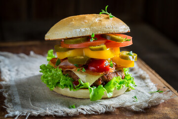 Spicy hamburger with bacon, beef and vegetables