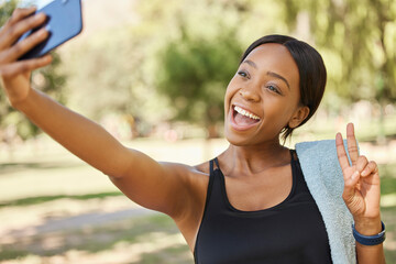 Selfie, peace and park with a sports black woman taking a photograph outdoor during fitness or exercise. Social media, towel and nature with a female athlete posing for a picture while training