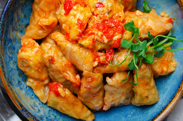 Homemade Cabbage rolls with meat, rice and vegetables also known as sarma, golubtsy, dolma on Rustic Background