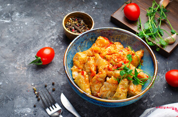 Homemade Cabbage rolls with meat, rice and vegetables also known as sarma, golubtsy, dolma on Rustic Background