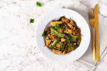 Stir fry chicken, green peas and green beans. Top view. Asian style