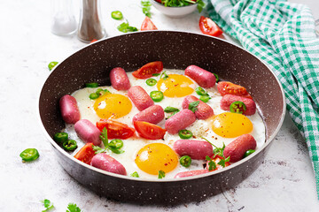 Homemade delicious american breakfast with  fried eggs,  sausages, and tomatoes. Concept of a healthy lifestyle