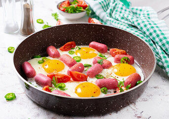 Homemade delicious american breakfast with  fried eggs,  sausages, and tomatoes. Concept of a healthy lifestyle