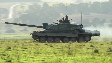 commander and gunner directing action in a British army FV4034 Challenger 2 ii main battle tank on a military combat exercise, Wiltshire UK