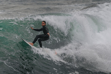 movement 1. young man surfs a wave in Telde, Gran Canaria. Canary Islands