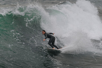 movement 2. young man surfs a wave in Telde, Gran Canaria. Canary Islands