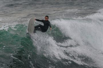 movement 3. young man surfs a wave in Telde, Gran Canaria. Canary Islands