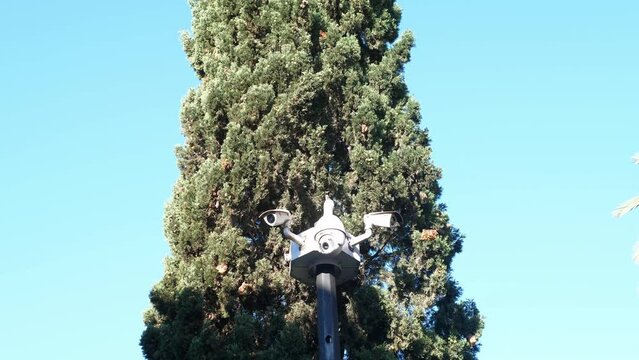 CCTV camera on the street in the park. The concept of security in the city.