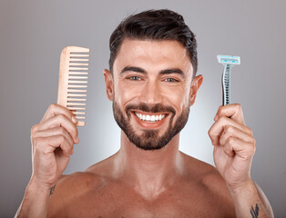 Portrait, shaving and comb with a man model holding a razor in studio on a gray background for...