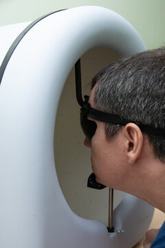 A man checks his vision, a person passes perimetry
