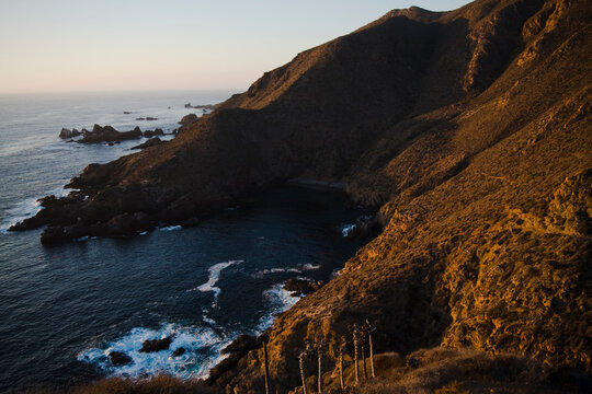 The sun sets on the steep bluffs above La Bufadora near Ensenada, Baja California, Mexico.