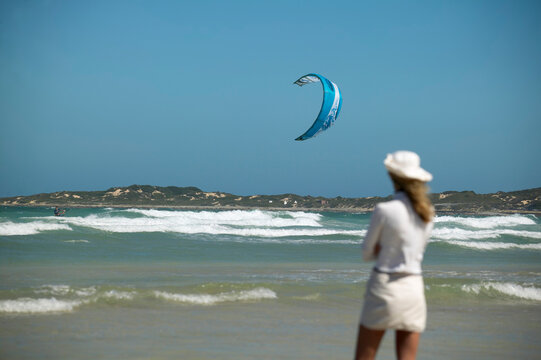 Girl watches kiteboarder, Still Baai, South Africa