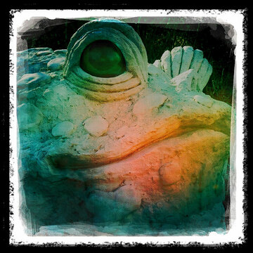 Giant Frog suclpture in a garden.