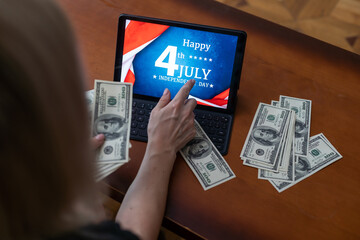 American flag and banknotes 100 USA dollar bill in the USA financial sector on a digital tablet.