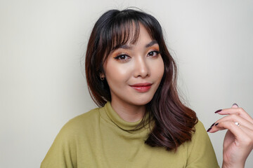 A beauty cheerful face of Asian young model wearing green top. Skincare beauty facial treatment, spa, female health concept.