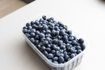 Blueberries in a plastic container, fresh berry.