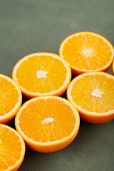 Halves of juicy oranges on a green background. Half cut oranges for making juice. Close up