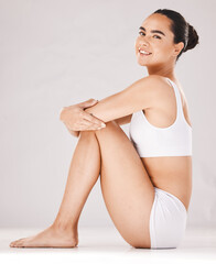 Fototapeta premium Portrait, woman in underwear and healthy lifestyle for body care or wellness on grey studio background. Female, girl or diet with body positivity, self care or natural health for beauty or motivation